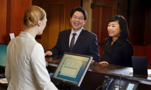 The Inn at Virginia Tech, guests checking in at the front desk, hospitality, service, staff